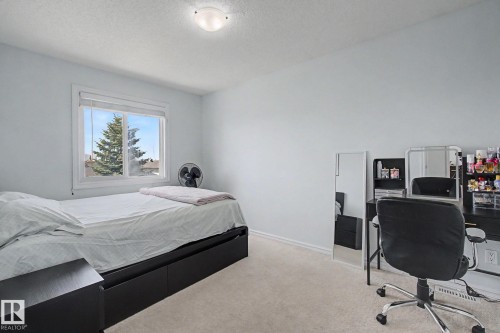 Carpeted flooring, a window with white trim, and a flush mount ceiling light fixture - 3236 21 Street Nw, Edmonton, AB - Indoor Photo Showing Bedroom