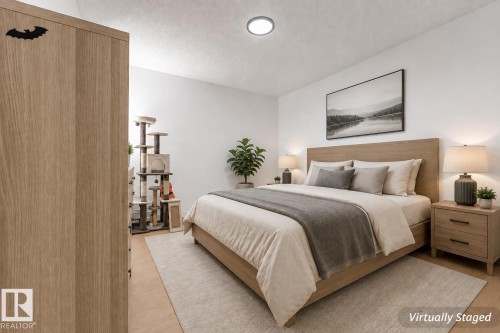 Wood-finish flooring with a neutral area rug - #416 2305 35A Av Nw, Edmonton, AB - Indoor Photo Showing Bedroom