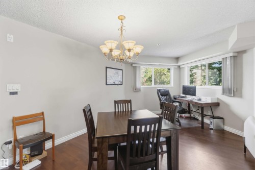 Recessed lighting and a multi-light chandelier illuminate the interior - #104 10221 111 St Nw, Edmonton, AB - Indoor Photo Showing Dining Room