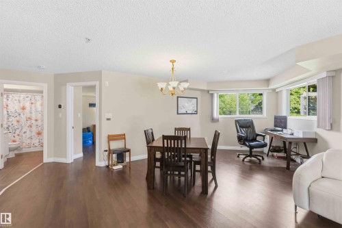 Expansive interior with wood-finish flooring, recessed lighting, and multiple windows - #104 10221 111 St Nw, Edmonton, AB - Indoor