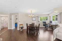 Expansive interior with wood-finish flooring, recessed lighting, and multiple windows - 