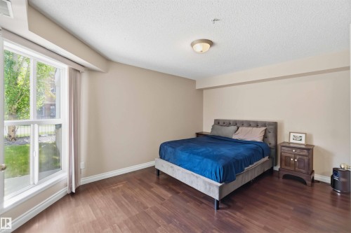 Hardwood-style flooring throughout - #104 10221 111 St Nw, Edmonton, AB - Indoor Photo Showing Bedroom