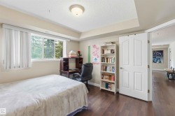 Wood-finish flooring, white paneled door, and a recessed ceiling feature - 