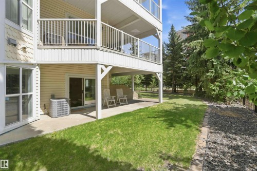 Ground-level concrete patio with direct outdoor access via a sliding glass door - #104 10221 111 St Nw, Edmonton, AB - Outdoor