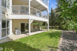 Ground-level concrete patio with direct outdoor access via a sliding glass door - 