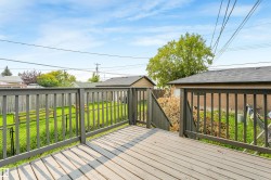 Wood deck with painted railings, providing an elevated outdoor space - 