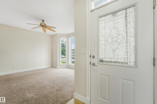 Entry door with decorative glass panel and side light - 10234 155 Street Nw, Edmonton, AB - Indoor Photo Showing Other Room