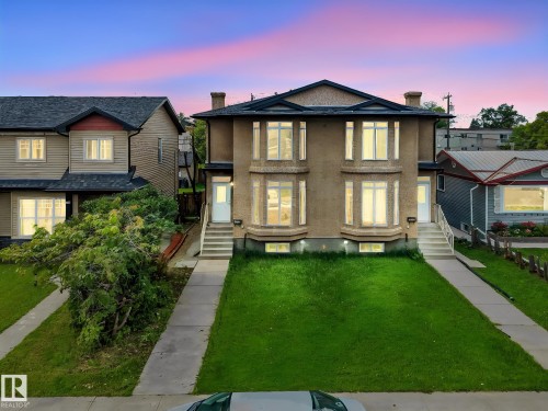 Stucco exterior, prominent bay windows, symmetrical entrances, concrete walkways, and green lawn areas - 10234 155 Street Nw, Edmonton, AB - Outdoor With Facade