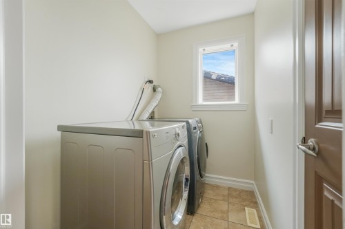 Utility space featuring tiled flooring and a single-pane window - 10234 155 Street Nw, Edmonton, AB - Indoor Photo Showing Laundry Room