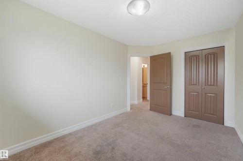 Neutral-toned walls, carpeted flooring, and a flush mount ceiling light fixture - 10234 155 Street Nw, Edmonton, AB - Indoor Photo Showing Other Room