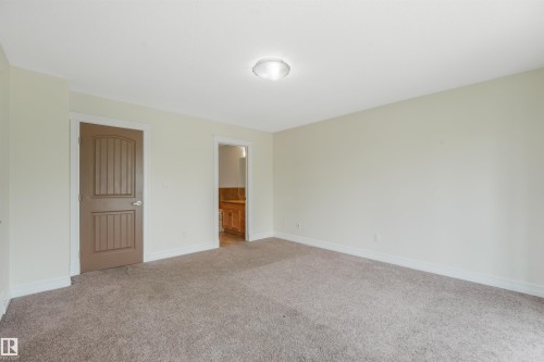 Neutral-toned walls complement the plush carpet flooring - 10234 155 Street Nw, Edmonton, AB - Indoor Photo Showing Other Room