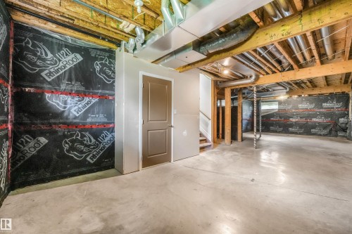 Expansive basement featuring polished concrete flooring, exposed wooden beam ceiling with recessed lighting, and flexible open layout - 10234 155 Street Nw, Edmonton, AB - Indoor Photo Showing Basement