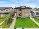 Duplex featuring a stucco exterior, multiple bay windows, individual front entries, and a shingled roof - 10234 155 Street Nw, Edmonton, AB  - Outdoor With Facade 