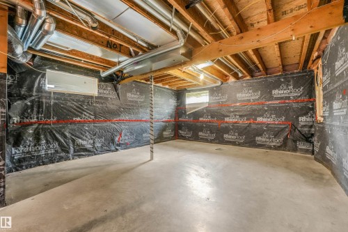 Unfinished basement featuring exposed wood joists, concrete flooring, and visible ductwork - 10234 155 Street Nw, Edmonton, AB - Indoor Photo Showing Basement