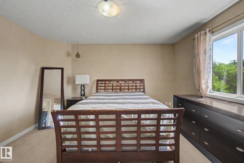 Recessed window with a built-in dark wood dresser, white window frame, and neutral wall paint - 9935 155 Street Nw, Edmonton, AB - Indoor Photo Showing Bedroom