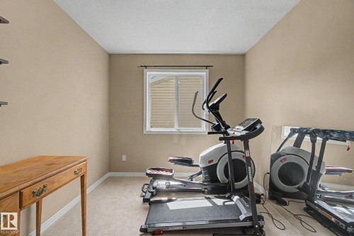Neutral tone wall paint, white window trim, and carpeted flooring - 9935 155 Street Nw, Edmonton, AB - Indoor Photo Showing Gym Room