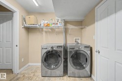 Functional laundry area featuring a wire shelf, tile-look flooring, and neutral wall paint - 