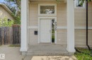 Exterior featuring a front entry door with transom window and sidelight, concrete porch, and vertical house numbers - 9935 155 Street Nw, Edmonton, AB  - Outdoor With Exterior 