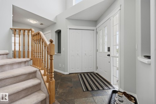 Two-story entry with natural wood-finish staircase and carpeted treads - 15 Orchid Place, St. Albert, AB - Indoor Photo Showing Other Room