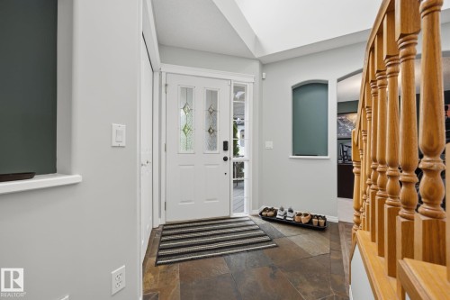 Entryway featuring a decorative glass panel door, side light, and natural stone tile flooring - 15 Orchid Place, St. Albert, AB - Indoor Photo Showing Other Room