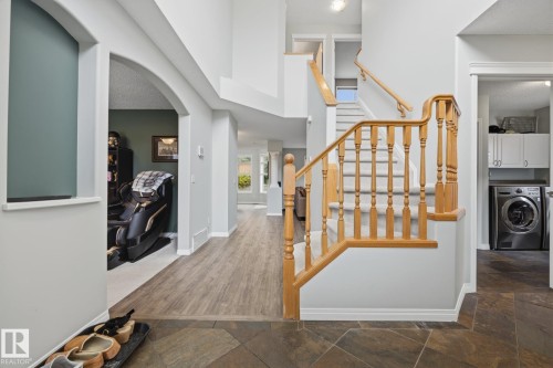 Two-story foyer with a natural wood staircase and banister, leading to an upper level - 15 Orchid Place, St. Albert, AB - Indoor Photo Showing Other Room