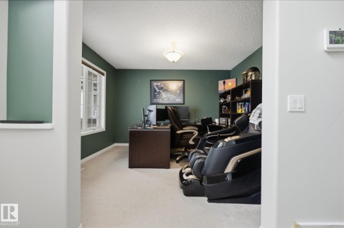 Recessed entry, neutral carpet flooring, recessed window, ceiling-mounted light fixture, and dark wall paint - 15 Orchid Place, St. Albert, AB - Indoor