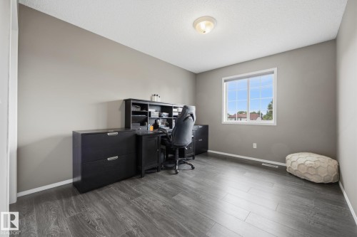 Wood-finish flooring, neutral wall tones, large window, and recessed lighting - 15 Orchid Place, St. Albert, AB - Indoor Photo Showing Office
