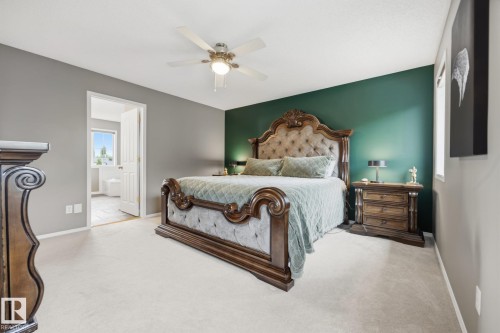 Plush carpeting, ceiling fan, and a prominent accent wall - 15 Orchid Place, St. Albert, AB - Indoor Photo Showing Bedroom