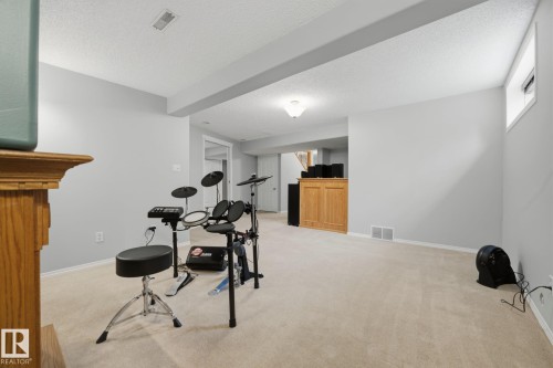Spacious room with light neutral wall paint, recessed lighting, and soft carpeting - 15 Orchid Place, St. Albert, AB - Indoor Photo Showing Other Room