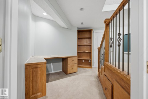 Built-in wood-finish L-shaped desk with drawers - 15 Orchid Place, St. Albert, AB - Indoor