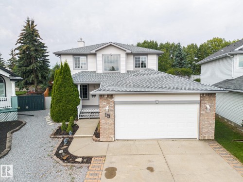 Two-story residence featuring white siding and a prominent attached two-car garage - 15 Orchid Place, St. Albert, AB - Outdoor