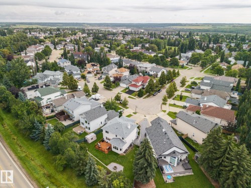 Residential neighborhood with mature trees, paved streets, and a mix of single-family homes - 15 Orchid Place, St. Albert, AB - Outdoor With View