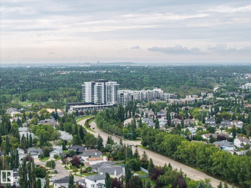 Expansive aerial perspective showcasing a residential neighborhood with established homes, tree-lined streets, and multiple apartment buildings in the distance - 15 Orchid Place, St. Albert, AB - Outdoor With View
