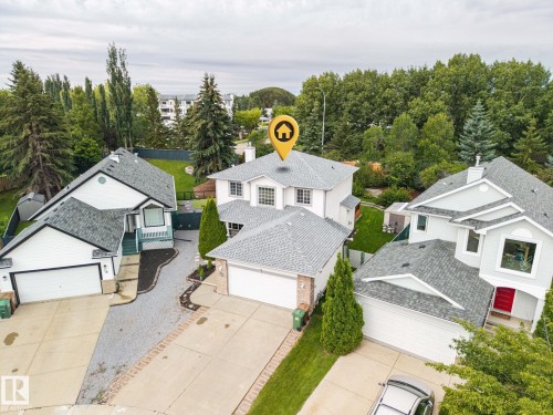 Aerial perspective showcasing a light-colored exterior, multiple garages, and sloped roofing - 15 Orchid Place, St. Albert, AB - Outdoor