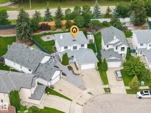 Two-story residence featuring a gray shingle roof, attached garage, paved driveway, and mature landscaping - 15 Orchid Place, St. Albert, AB - Outdoor With View