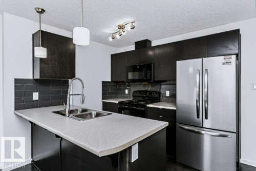 #415 508 Albany Way Nw, Edmonton, AB - Indoor Photo Showing Kitchen With Double Sink