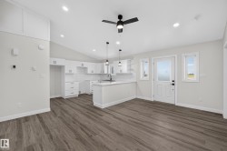 Living Space # 1 Open concept living space featuring wood-finish flooring and a vaulted ceiling - 