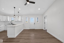 Living Space # 1 Open-concept living space featuring wood-finish flooring and recessed lighting - 