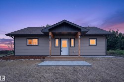 Contemporary ranch-style exterior with neutral siding and dark trim - 