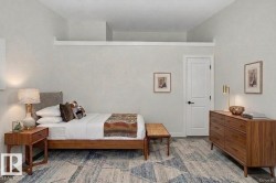 AI Staging to showcase space- Bedroom featuring a contemporary ceiling design, light gray walls, a white paneled door with matte black hardware, and wood-finish flooring partially covered by an area rug - 