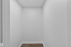 Living Space # 2  Recessed storage area featuring wood-finish flooring, white baseboards, and neutral wall finishes - 