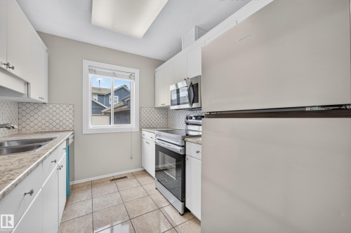 #14 14803 34 St Nw, Edmonton, AB - Indoor Photo Showing Kitchen With Double Sink