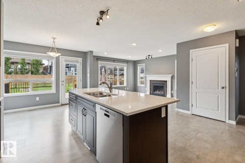 5935 18 Avenue Sw, Edmonton, AB - Indoor Photo Showing Kitchen With Fireplace With Double Sink