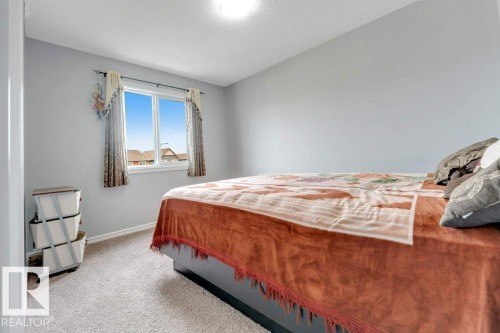 Recessed ceiling lighting, light gray wall finish, carpet flooring, and a double-pane window - 2436 18 Avenue Nw, Edmonton, AB 
