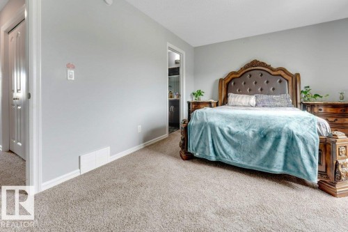 Wall-to-wall carpeting and light gray wall paint create a neutral aesthetic - 2436 18 Avenue Nw, Edmonton, AB 