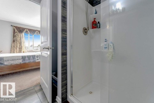 Shower with a glass enclosure, integrated shelving, and a brushed nickel shower head - 2436 18 Avenue Nw, Edmonton, AB 