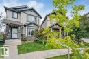 Two-story exterior with siding and stone accents, covered front entry, and a concrete pathway - 2436 18 Avenue Nw, Edmonton, AB  - Outdoor With Facade 