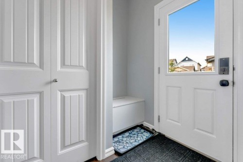 White paneled entry door with an upper glass insert - 2436 18 Avenue Nw, Edmonton, AB 