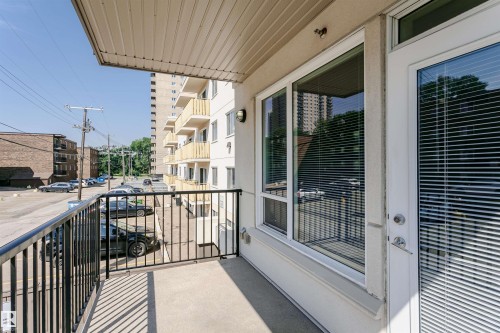 Private balcony featuring concrete flooring and a black metal railing - #208 9907 91 Av Nw, Edmonton, AB - Outdoor With Balcony With Exterior