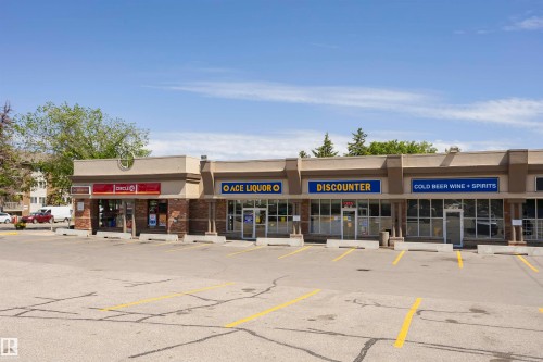 Commercial strip mall featuring multiple retail units with individual storefronts - #208 9907 91 Av Nw, Edmonton, AB - Outdoor